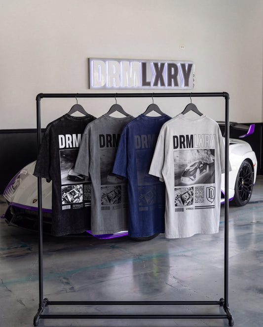 DRMLXRY Spec Sheet Tees in front of a supercar lineup