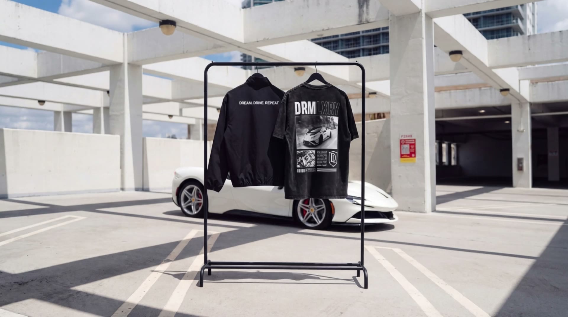 The DRMLXRY Collection on a rack next to a white Ferrari
