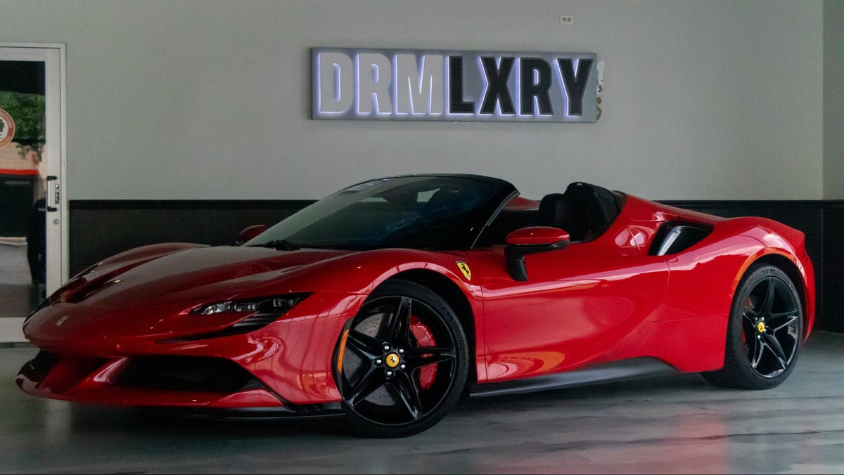 Red Ferrari SF90 Spider in the DRMLXRY showroom